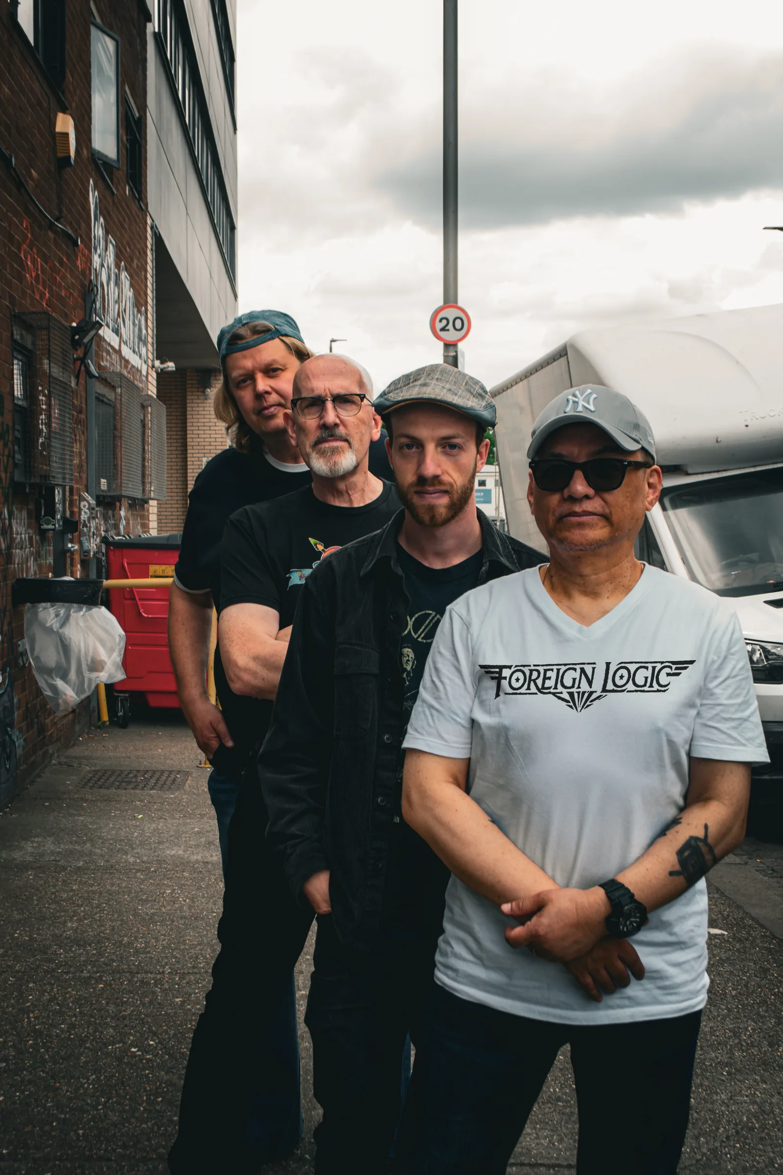 Foreign Logic band photo with white shirt logo